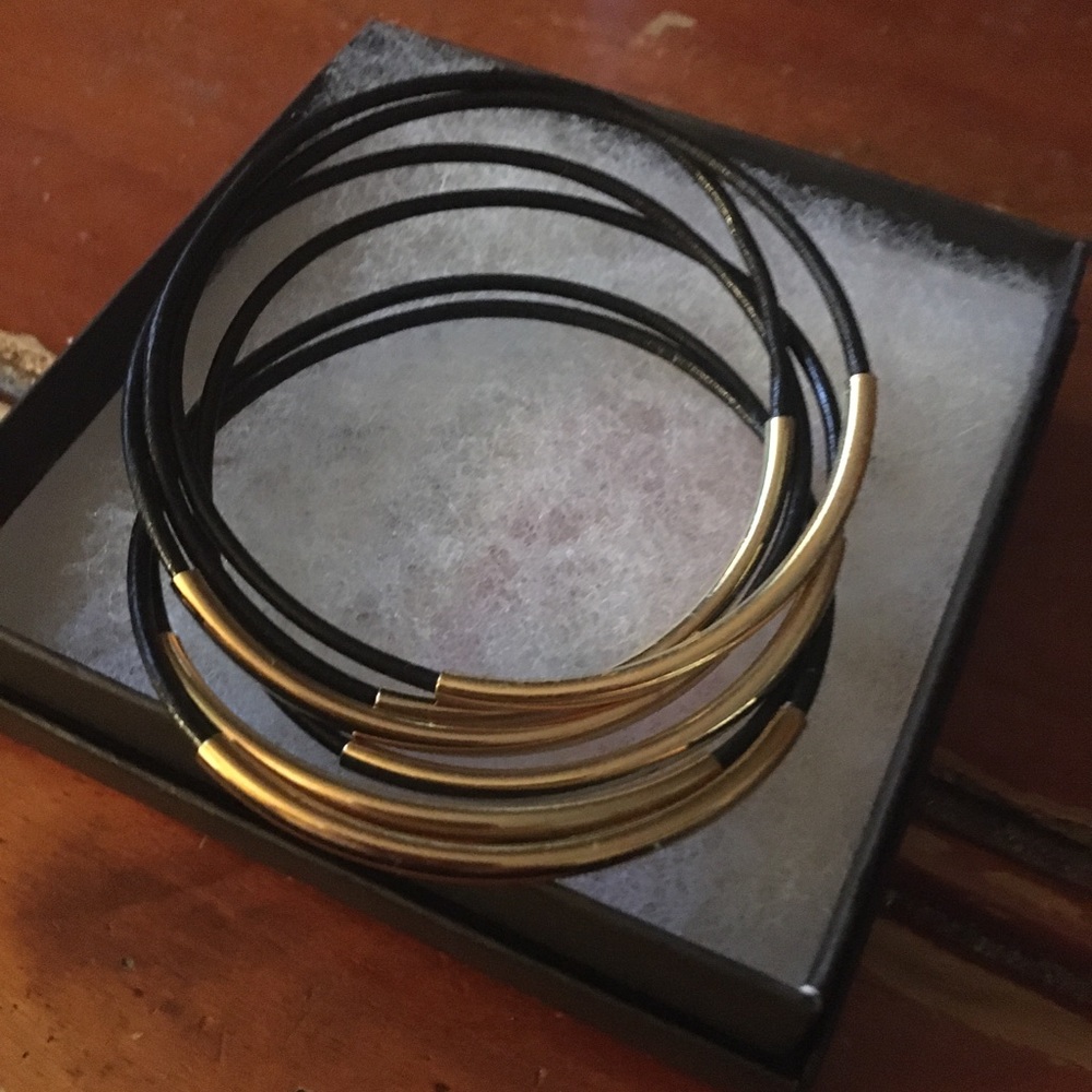 6 leather and gold tone bracelets.